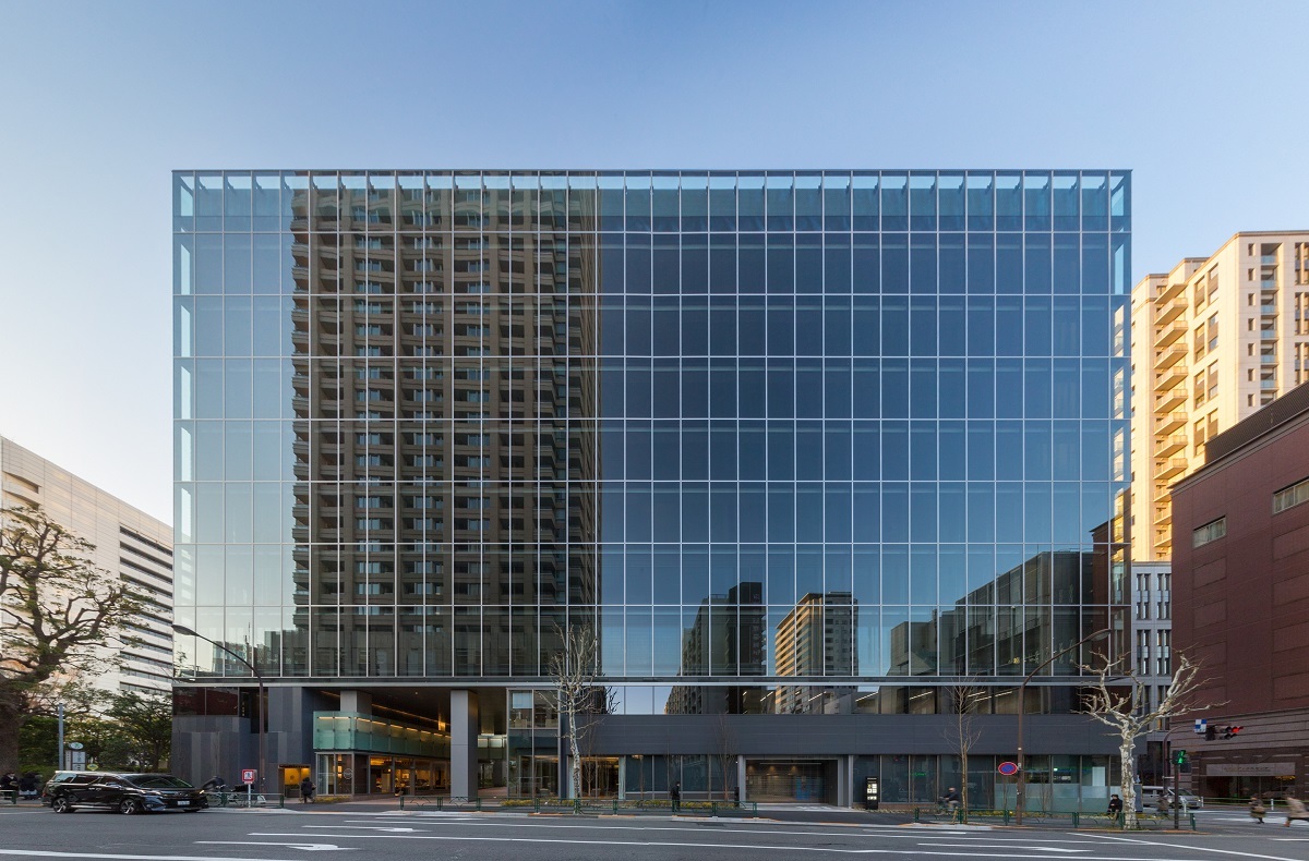 Exterior view of the office building with full glass walls.