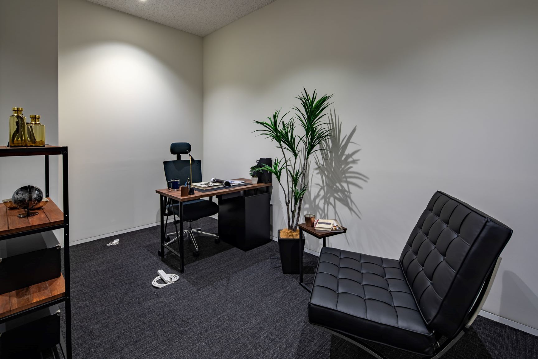 The room is equipped with functional office furniture.
